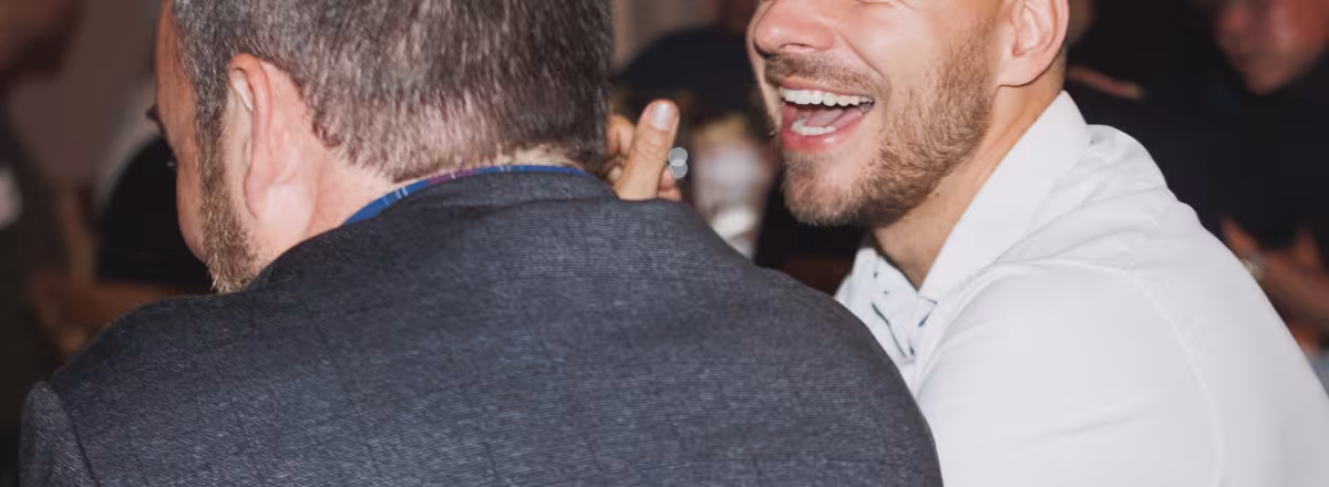 Two men in conversation laughing